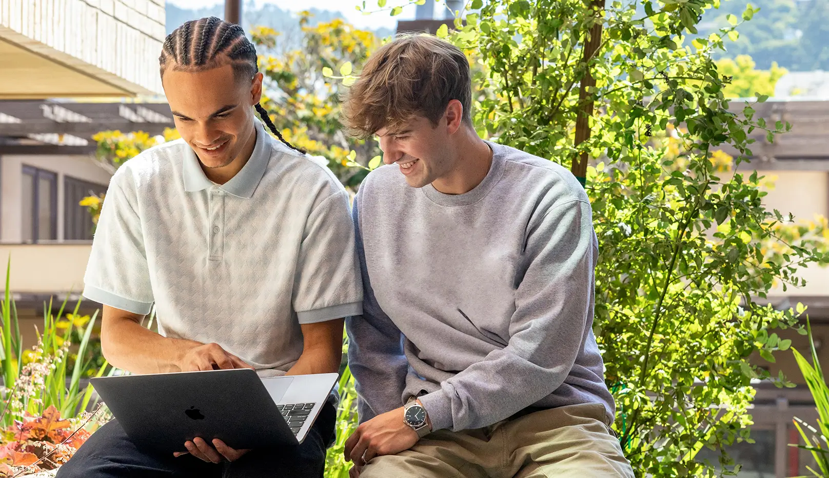 two friends looking at a laptop